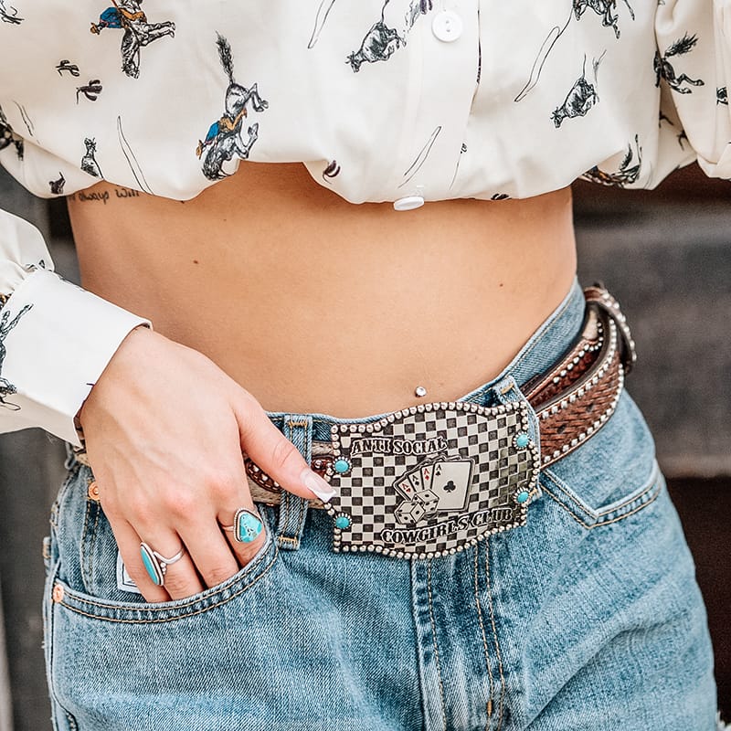 A woman wearing a belt buckle with a special design from our influencers